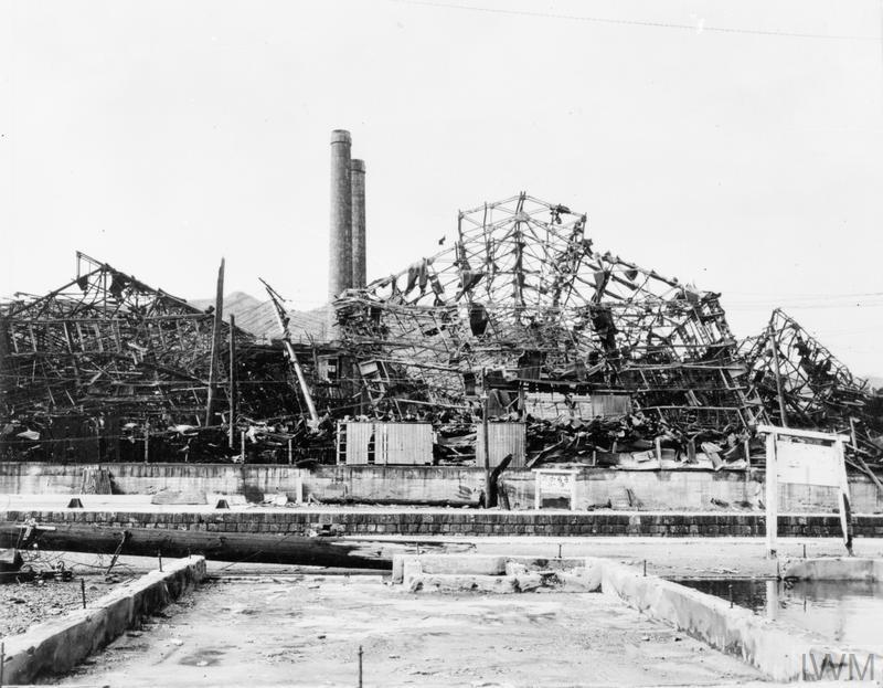 (Q (HS) 828) Ruined sheds at the Mitsubishi Steel and Armaments factory, 760 metres away from the hypocentre at Nagasaki. The whole of the steel framework has been distorted by the effect of the blast. Original Source: http://www.iwm.org.uk/collections/item/object/205087492