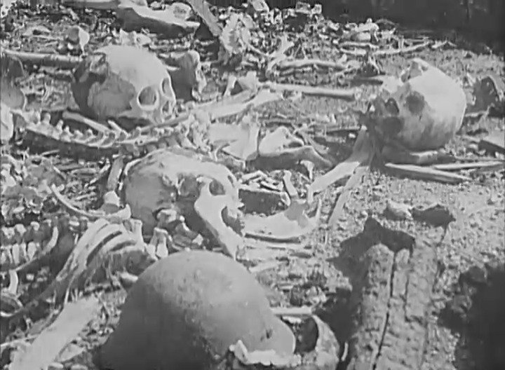 Skulls and bones scattered among the wreckage, c. October 1945. Still frame from the National Archive Catalog, 111-ADC-10030.
