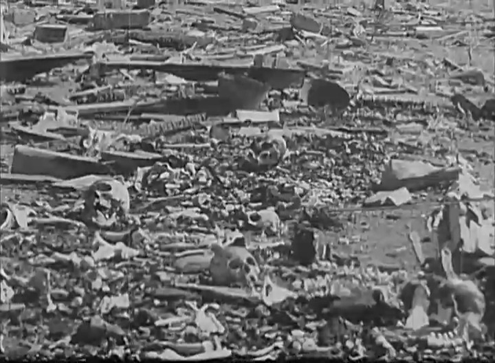 Skulls and bones scattered among the wreckage, c. October 1945. Still frame from the National Archive Catalog, 111-ADC-10030.